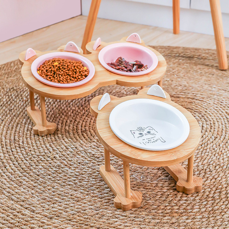 Raised wooden cat food bowls on rug